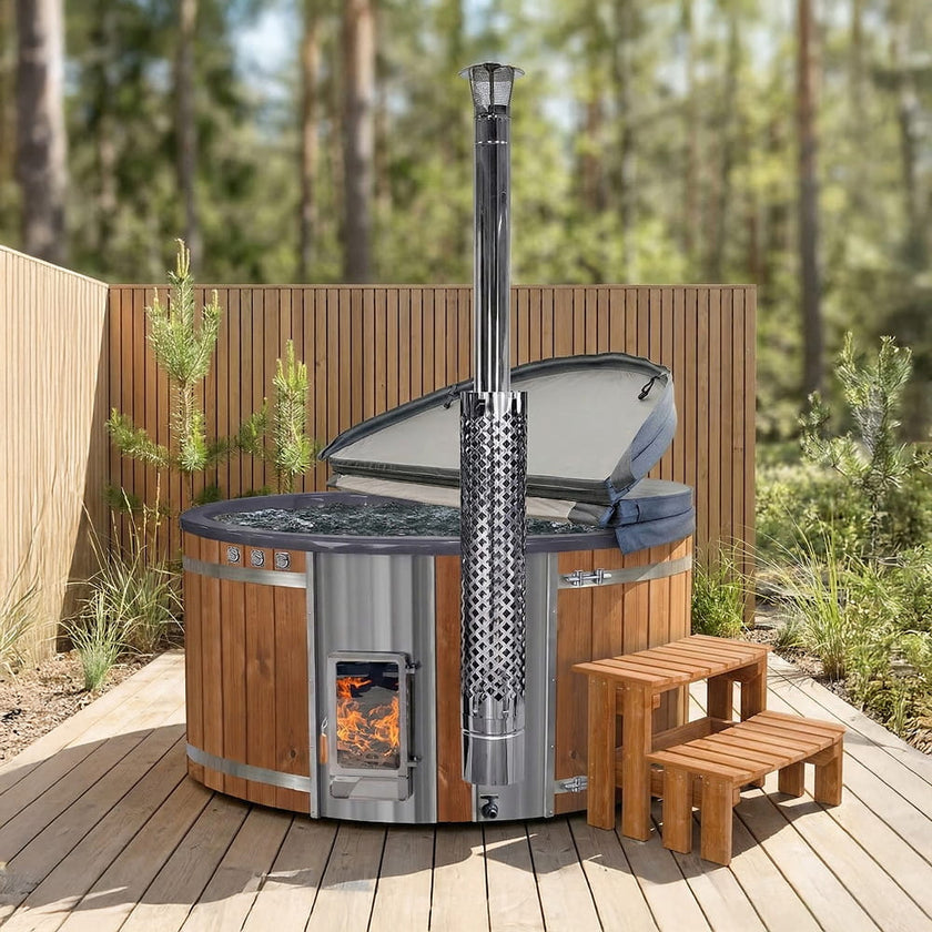 Outdoor hot tub with wood-fired stove Verta on a wooden deck with trees in the background